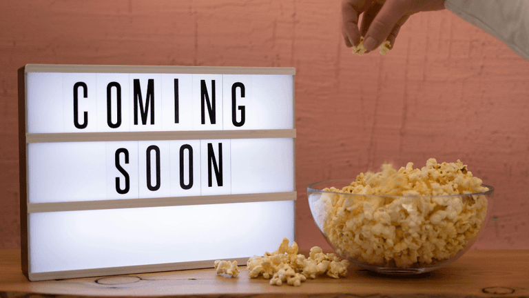 Lightbox displaying "Coming Soon" beside a bowl of popcorn on a wooden table.