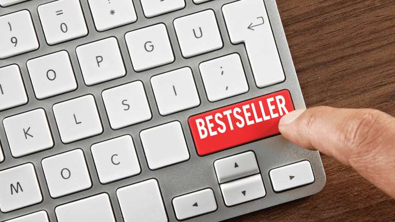 Finger pressing a keyboard key labeled "Bestseller."