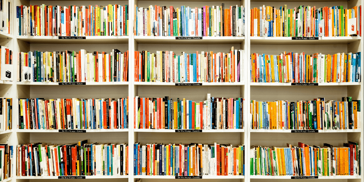 A colorful bookshelf filled with neatly organized books in various sizes and colors