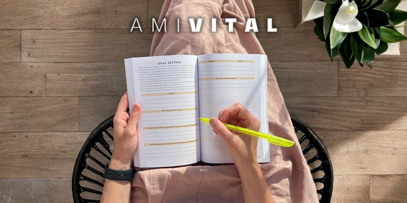 Hand writing in goal-setting section of AmiVital's Health Code book, with a focus on personal health transformation.