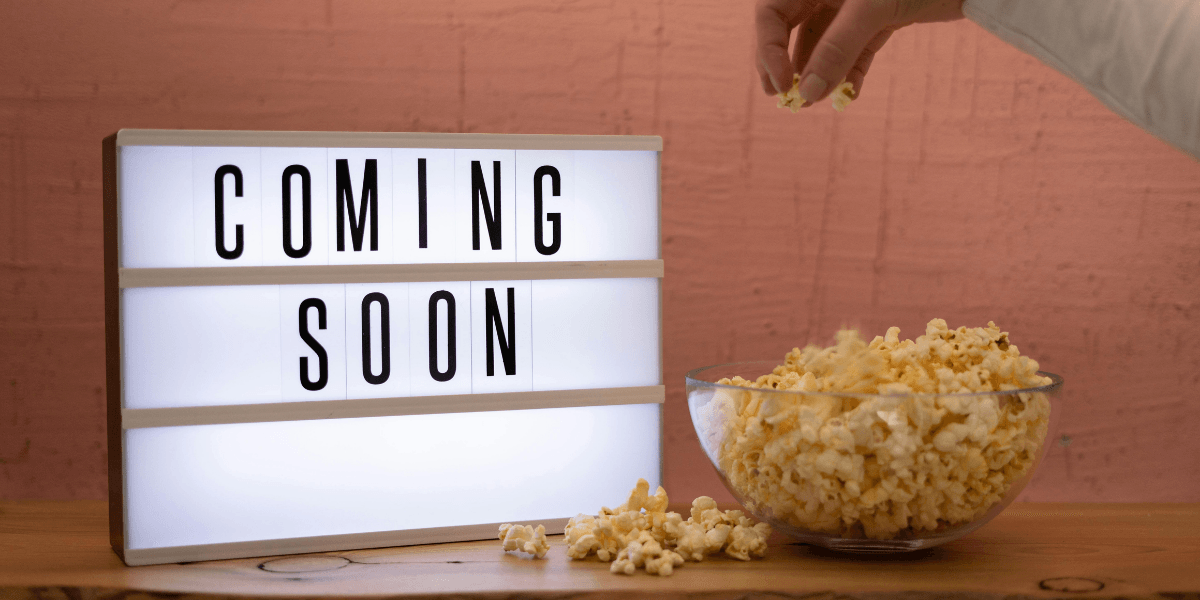 Lightbox displaying "Coming Soon" beside a bowl of popcorn on a wooden table.