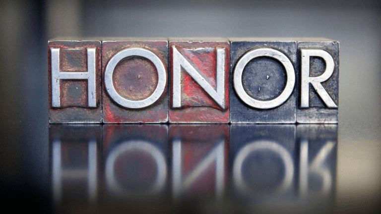 Metal letter blocks spell out the word "HONOR" with a reflective surface beneath them