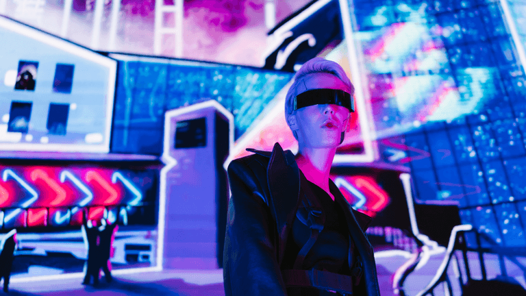 Futuristic figure with sleek glasses stands against a vibrant neon city backdrop