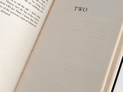 Open book page displaying the word "TWO" in bold text