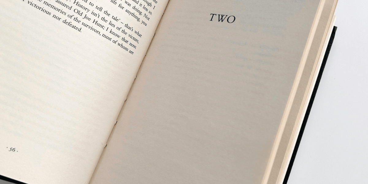 Open book page displaying the word "TWO" in bold text
