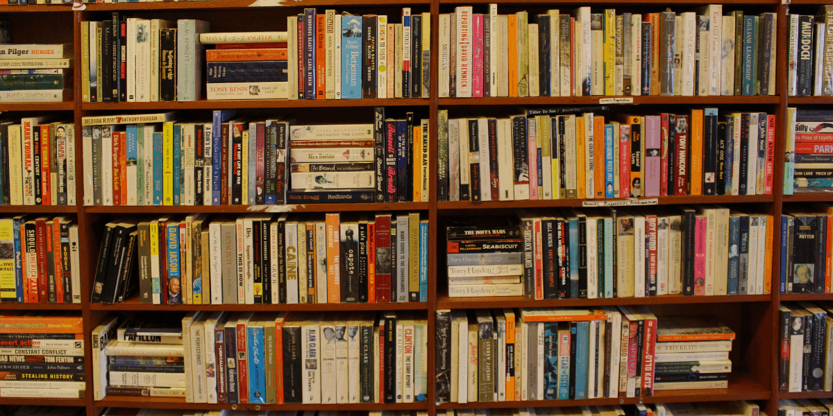 Bookshelves filled with books in a bookstore or library during the summer reading season.