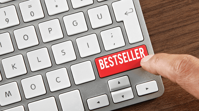 Finger pressing a keyboard key labeled "Bestseller."
